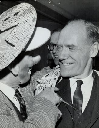 Liberal Mitchell Sharp, shown here being congratulated by magician Tic Tocher wearing a rubber mask, drew 22,047 votes to win the former Conservative (...)