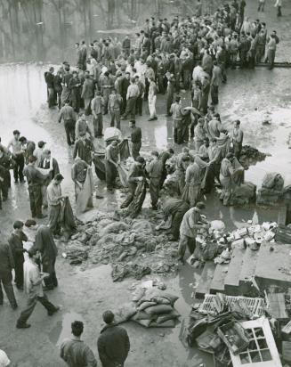 Sodden debris in the courtyard of the reformatory is cleaned up by prisoners after the surrender
