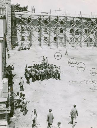 Heat takes its toll of hungry, sweltering prisoners in the sun-scorched yard of the Ontario reformatory at Guelph as five men can be seen collapsed on the ground in circles at right