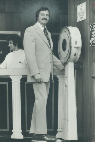 Ken Carmen, assistant advertising manager of Vic Tanny's, models a 2-button doubleknot suit for spring.