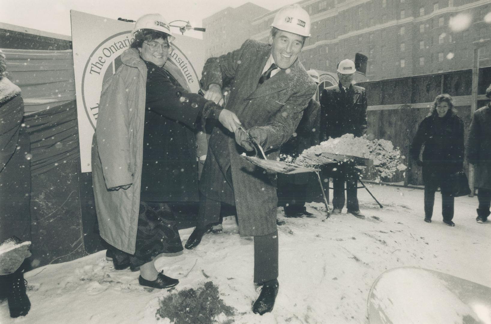 Digging in for health's sake: Ken Clarke, chairman of Princess Margaret Hospital, gives a heave of the shovel under the watchful eye of Ontario Health Minister Elinor Caplan at ground-breaking ceremonies yesterday for the new hospital on University Ave.