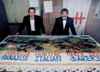 Hunt takes the cake: Organizer Domenic Commisso, right, and restaurant manager Antonto Stranges show off the cake made for the Hunder's Party, staged by the Mississauga Italian Canadian Association at La Mirage Banquet Hall to raise money for the association and the Lung Association of Peel.