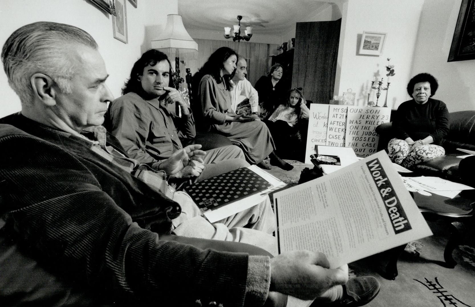 Shared loss: Matthew (Al) Cripps reads a protest sheet as Mark Toljagic looks on at a self-help meeting for the relatives of workers killed on the job. We have no rights at all, Cripps says.