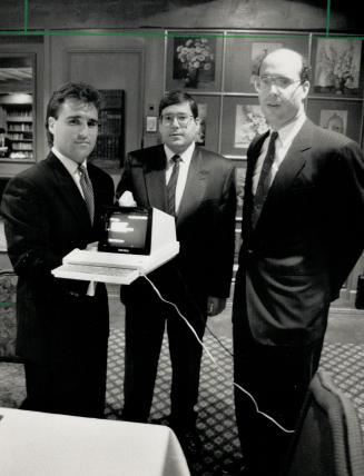 Marketing information: From left, David Cynamon, Steven Reichmann and Bruce Bronfman display a computer their company, Hav-Info, sells to get stock market date.