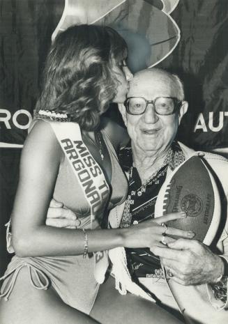 Kiss from the new Miss Agro, Albert (Eppie) Epstein, the 87-year-old honorary coach of the Argos, was among the first to welcome the new Miss Toronto Argonaut 1983 to the club last night.