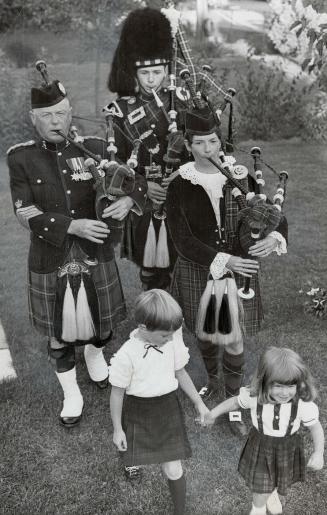 Blowing up a storm in the backyard is this family of pipers, Former Pipe Major Archie Dewar is with son Alex and daughter Frances Lawrie