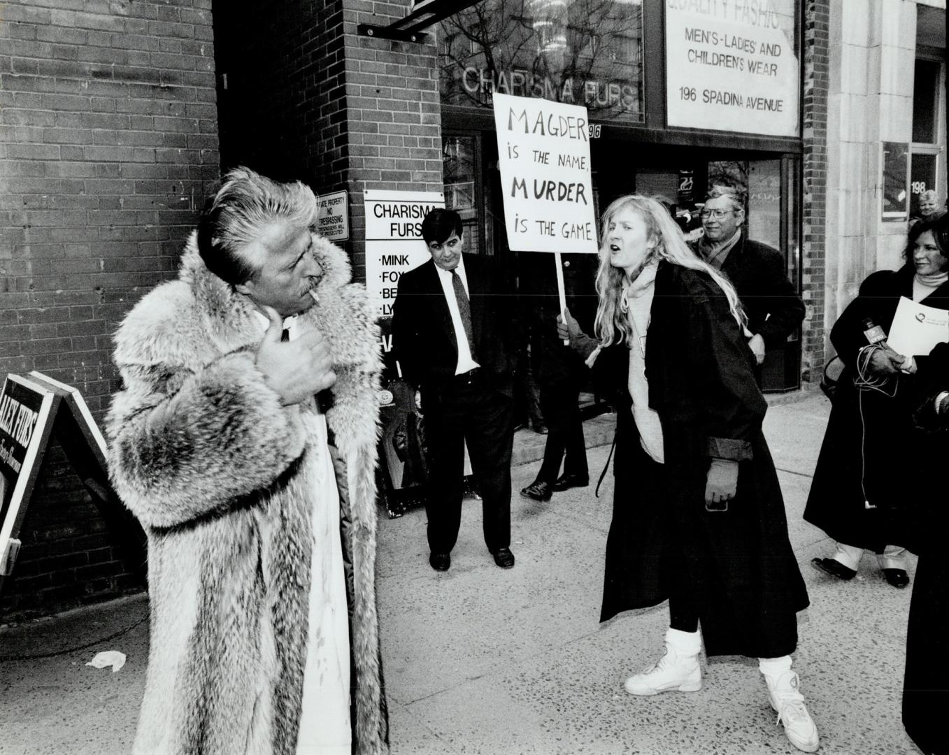 Street debate: Furrier Alex Dimitropolous, in coyote coat, and an anti-fur demonstrator clash yesterday on Spadina Ave. during a protest by about 200 activists.