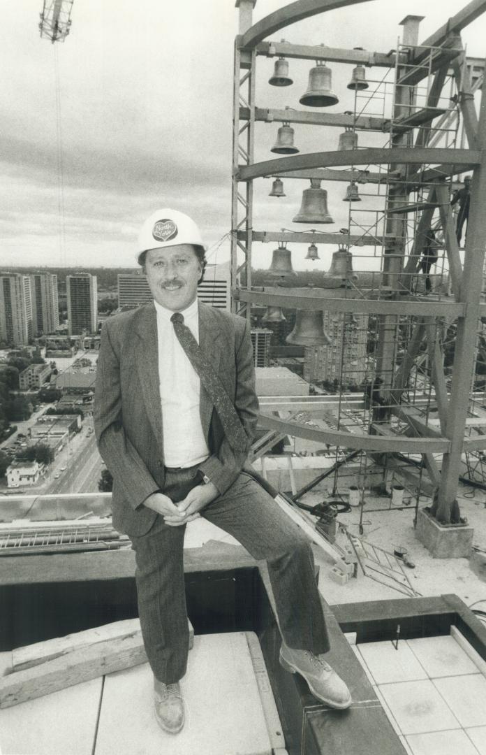 On top of things: Glen Garwood, who's co-ordinating the building of North York's $250 million city centre, stands on the 24th floor. In the background is the centre's computer-controlled carillon, with 14 bells made in Holland. At just 32, Garwood has ris