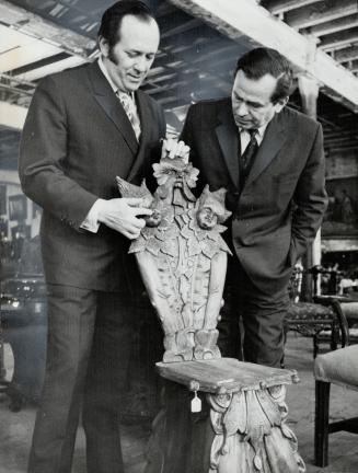 Ornately-carved antique chair which Frank Frank-furter (left) brought to Canada is examined by Heribert Hickl-Szabo