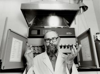 Fooling mother nature: Robert Garvin, vice-president and research chief of Cangene, a Mississauga biotechnology firm, stands before a DNA synthesizer machine being used to help delve into the mysterious world of genetic engineering