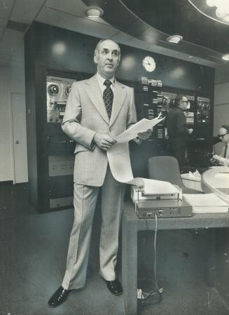 Arthur Harnett, company president, models glen check suit in lightweight all-wool blue and gray