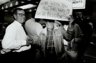 Retired auto workers speak out, Buzz Hargreaves, CAW Union president shakes hands with one of 500 retired union members who staged a protest yesterday at the union's national bargaining convention at the Sheraton Centre