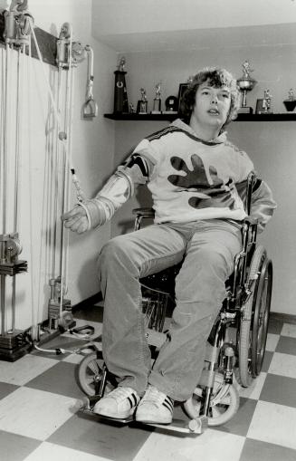 Paralyzed: 18-year-old Dave Hawkins works out in downstairs room equipped with special exercise equipment in an attempt to recover from almost paralysis suffered in a hockey game at Oakville