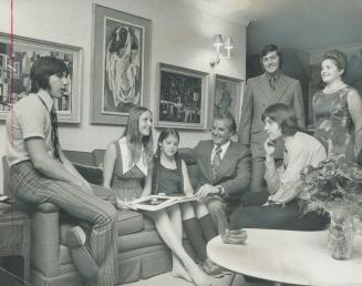 Mr. and Mrs. George Jordon are shown with their five handsome children in the living-room of their Scarborough home. Seen, from left, are, George, 15, Christine, 18, Barbara, 11, Jordon, John, 20, Mrs. Jordon, and David, 17, sitting on table. Family, proud of its Polish heritage, has a Polish Room in home.