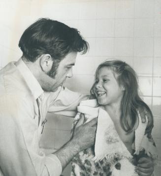 A loving smile is reward enough for any father rubbing down his daughter after her bath