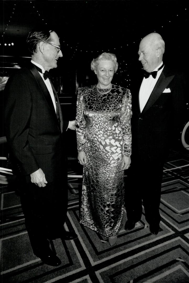 Toronto Symphony president David E. Howard chats with wife Beth, in gray chiffon and velvet gown, and Dr. Henning von Hassell, far right, consul general of Germany in Toronto.