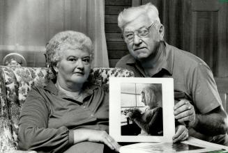 Daughter murdered: Irene and Brad Johnstone hold a photograph of their daughter, Karen Robinson, who was shot to death in June, 1975