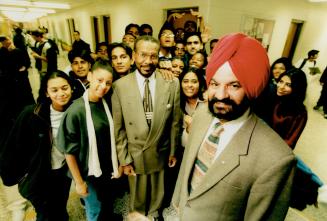 Home to all: Gurbax Malhi, right, who was Canada's first Sikh MP, mingles with principal Maurice Hudson and students at Westwood Secondary School.