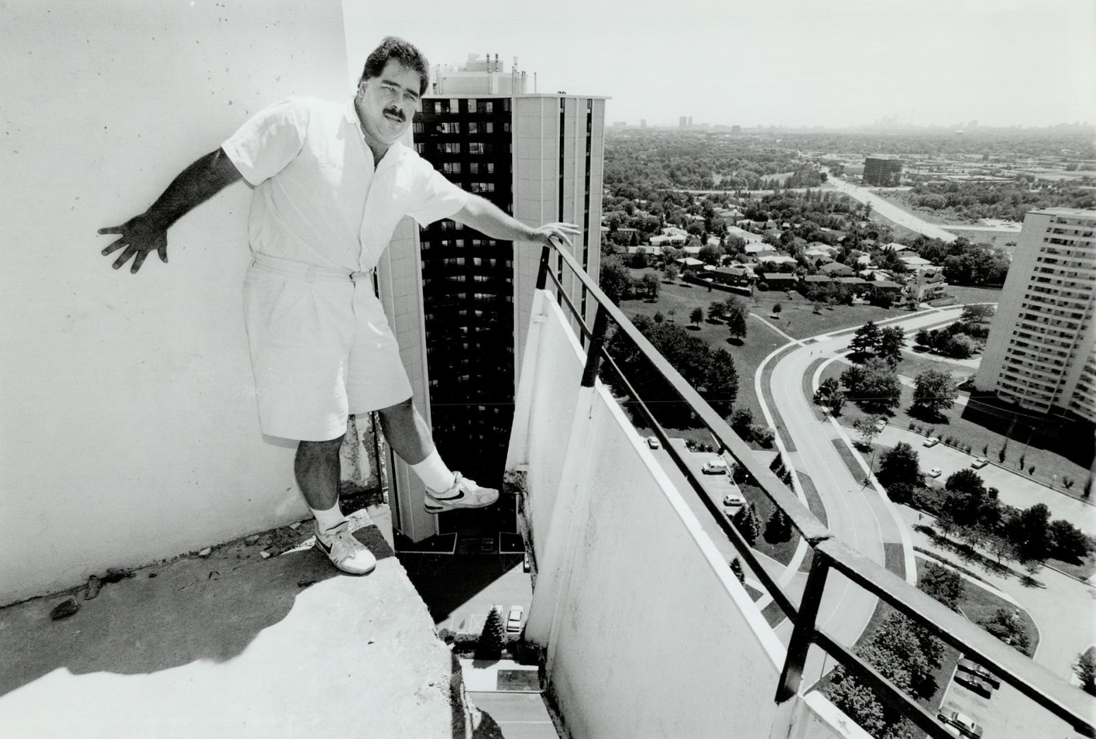 Close call: Michael Martin, 32, of Graydon Hall Drive shows how the balcony of his 25th floor penthouse has rusted away at the bottom