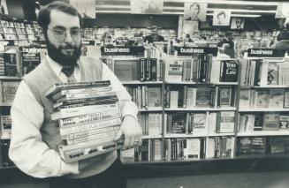 Elliott Milstein, manager of Fleet Books, displays some of his best sellers