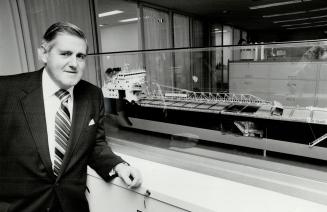 Model of bulk coal carrier behind Duncan Maxwell, of Upper Lakes Shipping is as immobile as six of firm's 26 ships.