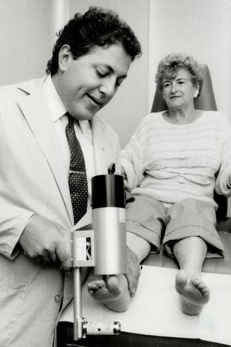 Helpful machine: Toronto podiatrist Hartley Miltchin uses a hightech x-ray device called Lixi Scope on Betty Hallett's foot