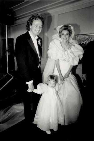 Above, bride and groom Kimberly and Peter Murphy place flower girl Sarah Cowie next to them for receiving line.