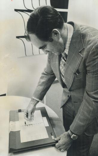 A punch-card voting system is demonstrated by Jack Poots, the Scarborough clerk and chief election officer
