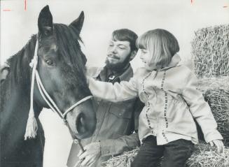 Miner dreams of Horses: Potash miner Don Prange and his daughter, Lorie, 5, pet his 5-year-old thoroughbred, Monty.