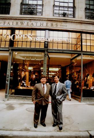Brothers Ron, left, and Gary Prosserman of Moores The Suit People stand in front of their flagship store, which opened this month in the old Fair weathers building at 100 Yonge St