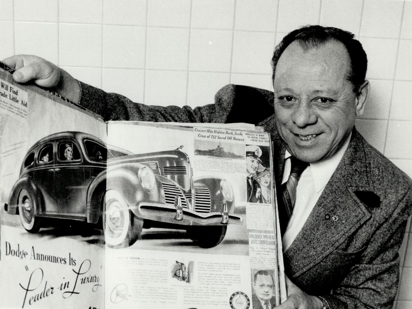 Collector of history: Louis Ricci, of North York, holds up a scrapbook with a picture of a 1936 Chrysler advertisement.