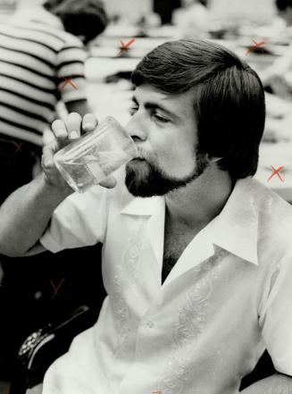 He's no flake: Bruce Ritchie drinks water he treated with solvent flakes he developed.