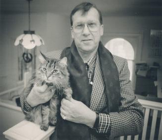 Paul Speck, holding the school cat, Fred, started the Annex Village Campus after leaving the Catholic priesthood and marrying some 25 years ago