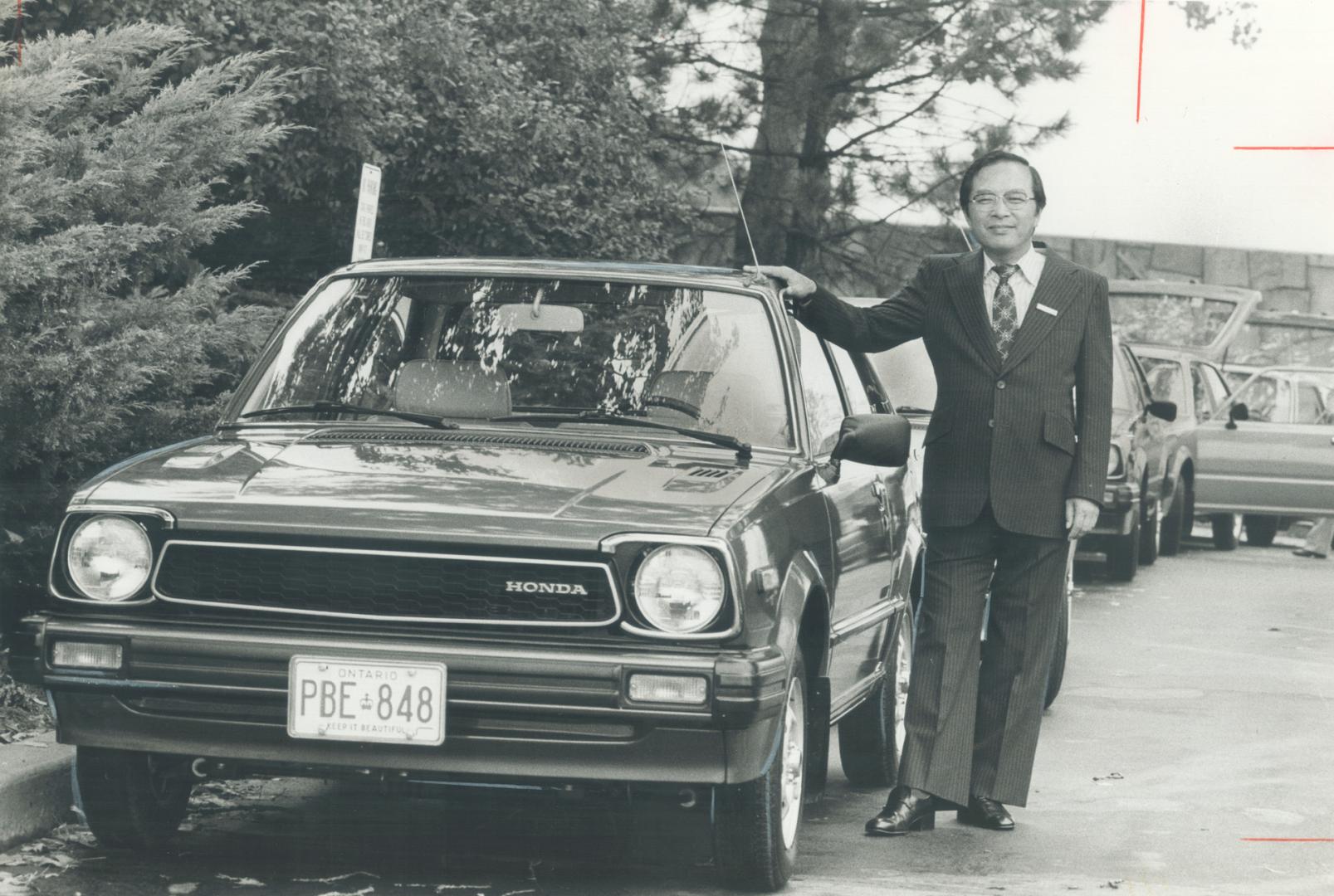 Holding the line on price: Masayoshi Tsukamoto, president of Honda of Canada, shows off a 1980 Civic at yesterday's press preview