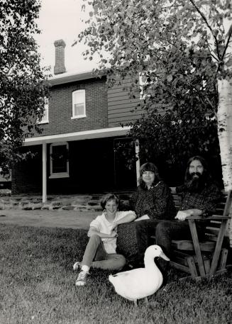 Home on the farm: Amy Palermo, Mona Harrison and Peter Thorn pose with Dabbles the duck in front of their newly purchased farmhouse.