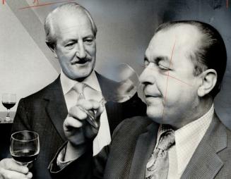 Chief Commissioner George Kitching (left) of the Liquor Control Board of Ontario and John Clement, Minister of Consumer and Commercial Relations, sample a Canadian wine - not the 1970 Bordeaux that sells for $73