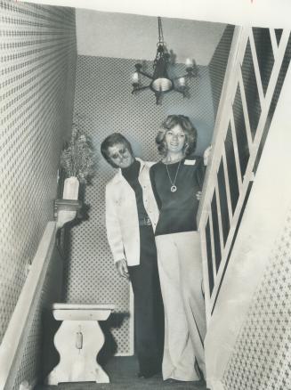 Canadian Golf Pro George Knudson, spokesman for the 496-suite development which Overlooks the sprawling Markland Wood Country Club, is shown above with his wife in the entry way to a two-storey, three-bedroom apartment