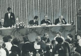 Soviet premier Alexei Kosygin (centre) eats dinner flanked by his interpreter, Victor Sukhodryev (left), and Gerard Filion, president of the Canadian Manufacturers' Association, which sponsored the dinner at the Ontario Science Centre last night