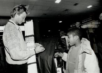 First T.O. Autograph: Mike Krusheinyski was barely off the plane on arrival in Toronto Friday night when he was stopped for an autograph by 9-year-old Wade Guthriner. Krushelnyski made his first start for Leafs against the Red Wings last night.