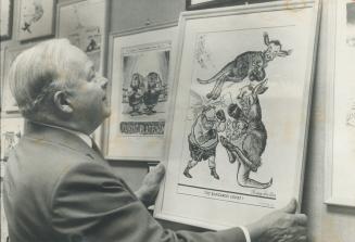 Battle relics of his political jousts, framed cartoons almost cover the wall of former mayor Allan Lamport's office in City Hall