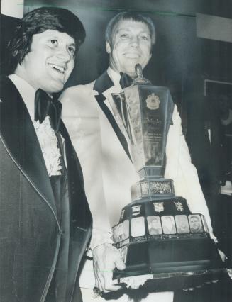 Canadian football's best: Ron Lancaster (right), resplendent in a lime green tuxedo, holds Schenley trophy for Canadian Football League's outstanding player, after award last night