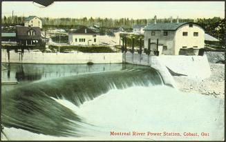 Huge cascade of water running out of a cement barrier.