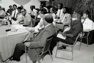 Muzzled orator: Dudley Laws, wearing beret, attends a news conference held to support him in his defence against slander suit.