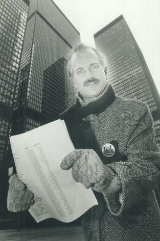 Wind-tunnel corner: Surrounded by office towers he says house backers of opponent June Rowlands, mayoral candidates Jack Layton hands out a 27-page list of contributors