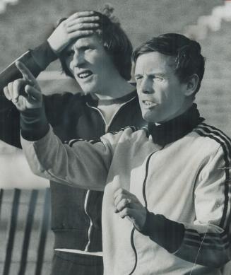 Cause for concern? Coach Graham Leggat (right), here discussing soccer tactics with one of two local players with Toronto Metros, John Fahy, will have additional problems this year