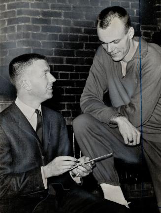 Coach and track ace plan mile tactics. Bill Eckersley (left) details way to runner Ergas Leps