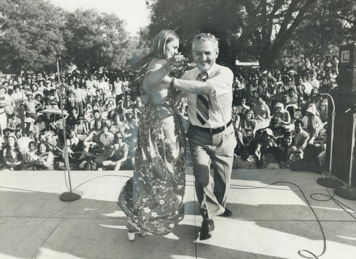 A former Miss Toronto, Pat Mazerick, 23, joins David Lewis, leader of the New Democratic Party, in a dance one one of the stages at yesterday's International Picnic
