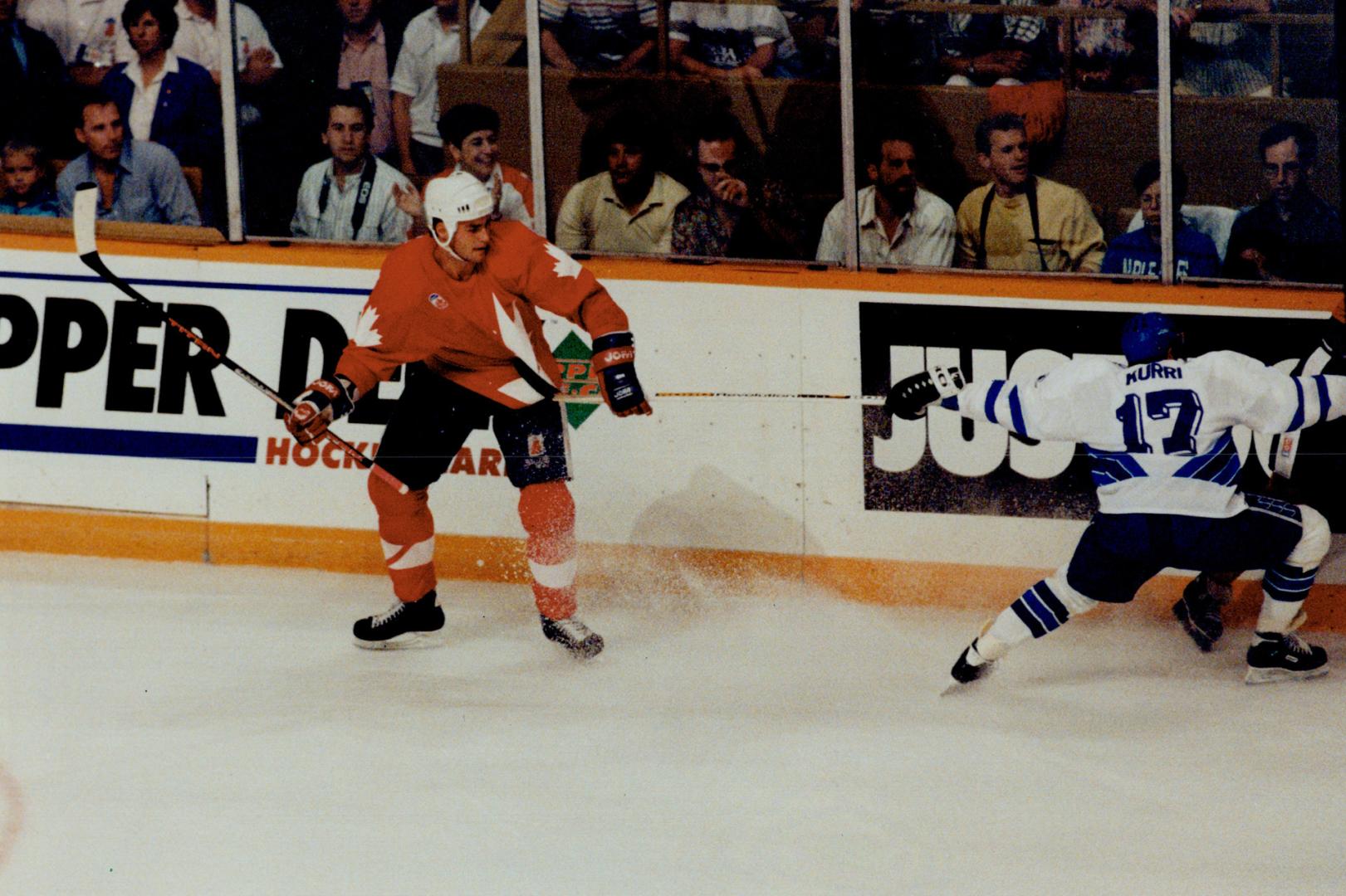 Keeping touch: Team Canada's Eric Lindros keeps Finnish sniper Jari Kurri tied up in first period last night at Gardens.