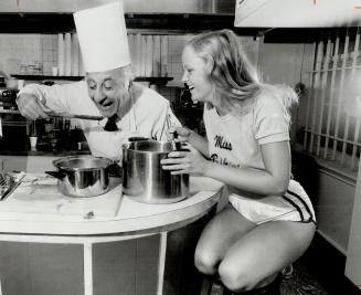 Miss Bikini of '79 Diane Heaslop samples pasta cooked by Johnny Lombardi, who's staging his 14th international picnic at Toronto Island next weekend.