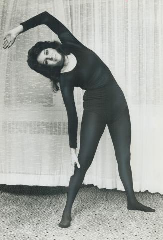 Myrna Lorrie, in Toronto for a guest appearance on the Tommy Hunter Show, does daily exercises in hotel room
